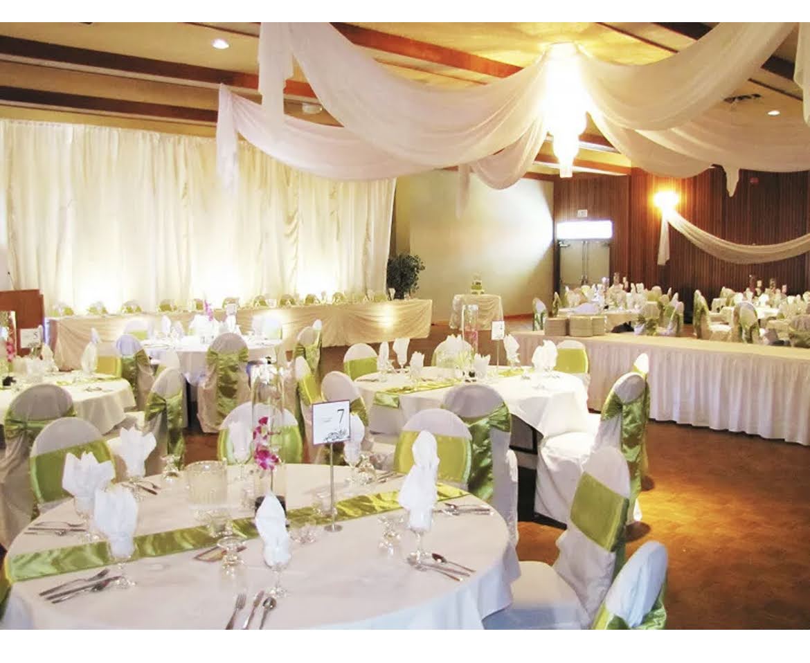 Elegantly covered reception tables with green and white decor