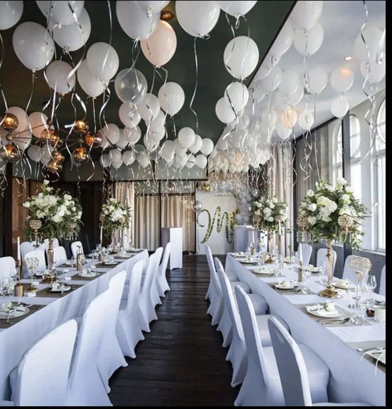 Beautiful venue with white balloon decoration and elegant table settings